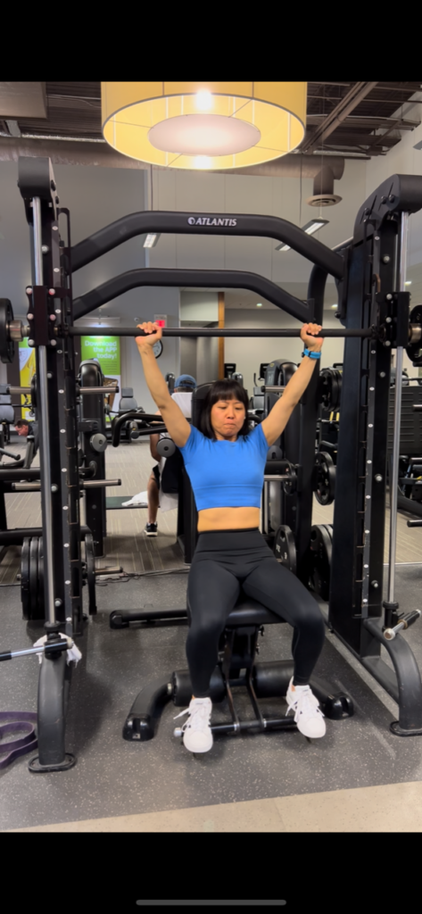 Nancy Yang Timmins doing barbell Shoulder Press